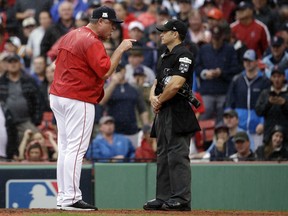 In this Monday, Oct. 9, 2017, photo, Boston Red Sox manager John Farrell, left, argues with home plate umpire Mark Wegner, right, during the second inning of Game 4 of baseball's American League Division Series against the Houston Astros in Boston. Boston's playoffs hopes ended with its second straight exit in the division series. Changes this offseason could be at the top. (AP Photo/Charles Krupa)