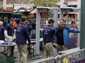 Spectators enter Fenway Park through a security checkpoint prior to Game 3 of baseball's American League Division Series between the Boston Red Sox and the Houston Astros, Sunday, Oct. 8, 2017, in Boston. (AP Photo/Charles Krupa)