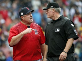 Boston Red Sox manager John Farrell, left, argues his point to crew chief umpire Ted Barrett after he was ejected during the second inning in Game 4 of baseball's American League Division Series against the Houston Astros, Monday, Oct. 9, 2017, in Boston. (AP Photo/Michael Dwyer)