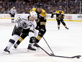 Los Angeles Kings right wing Dustin Brown (23) has his stick broken by Boston Bruins defenseman Zdeno Chara who received a slashing penalty on the play during the first period of an NHL hockey game in Boston, Saturday, Oct. 28, 2017. (AP Photo/Winslow Townson)