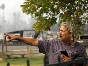 Jim Cook, manager of the Journey's End mobile home park, points to damage on the property Monday, Oct. 9, 2017, in Santa Rosa, Calif. Wildfires whipped by powerful winds swept through Northern California, sending residents on a headlong flight to safety through smoke and flames as homes burned. (AP Photo/Ben Margot)