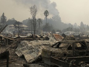 Remains from a wildfire sit at the Journey's End mobile home park on Monday, Oct. 9, 2017, in Santa Rosa, Calif. Wildfires whipped by powerful winds swept through Northern California early Monday, sending residents on a headlong flight to safety through smoke and flames as homes burned. (AP Photo/Ben Margot)