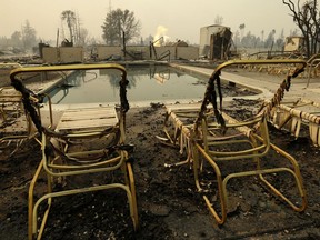 Fire burns from an open gas valve near the pool area at the Journey's End mobile home park on Monday, Oct. 9, 2017, in Santa Rosa, Calif. Wildfires whipped by powerful winds swept through Northern California early Monday, sending residents on a headlong flight to safety through smoke and flames as homes burned. (AP Photo/Ben Margot)