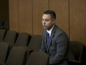 FILE - In this Sept. 30, 2016, file photo, then Contra Costa Sheriff's deputy Ricardo Perez waits for an arraignment hearing to begin in court at the Hayward Hall of Justice in Hayward, Calif. Charges have been dropped against Perez and a police officer in a California sex abuse case involving the teenage daughter of an Oakland police dispatcher. The dismissals this week marked the latest setback for prosecutors in the high-profile case involving the troubled Oakland Police Department and other agencies. (Anda Chu  /East Bay Times via AP, File)