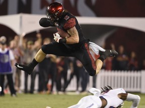 San Diego State fullback Nick Bawden (15) jumps over Boise State cornerback Tyler Horton (14) on a pass reception during the first half of an NCAA college football game Saturday, Oct. 14, 2017, in San Diego. (AP Photo/Denis Poroy)