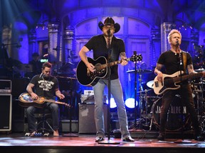 In this photo provided by NBC, Jason Aldean performs "I Won't Back Down" on "Saturday Night Live," Saturday, Oct. 7, 2017, in New York. "Saturday Night Live" has paid tribute to the victims of the Las Vegas mass shooting and the late rock superstar Tom Petty by opening its show with country star Aldean singing one of Petty's songs. (Will Heath/NBC via AP)