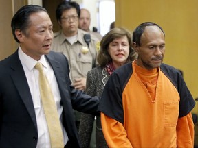 FILE - In this July 7, 2015 file photo, Jose Ines Garcia Zarate, right, is led into the courtroom by San Francisco Public Defender Jeff Adachi, left, and Assistant District Attorney Diana Garciaor, center, for his arraignment at the Hall of Justice in San Francisco. The bullet that killed Kate Steinle two years ago ricocheted off the ground about 100 yards away before hitting her in the back and later launching a criminal case at the center of a national immigration debate. A San Francisco police officer who helped supervise the investigation testified about the bullet's trajectory Monday, Oct. 30, 2017 at Zarate's trial. (Michael Macor/San Francisco Chronicle via AP, Pool, File)
