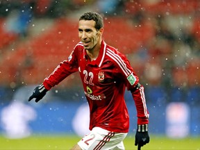 FILE - In this Dec. 9, 2012 file photo, Al-Ahly SC's Mohamed Aboutrika celebrates after scoring a goal against Sanfrecce Hiroshima during their quarterfinal at the FIFA Club World Cup soccer tournament in Toyota, Japan. A social media campaign to persuade former star midfielder Aboutrika to come out of retirement - and exile - to join Egypt's World Cup squad in Russia has stirred a storm in a country where politics and football often mix. The hugely popular Aboutrika already said no to a comeback, but pro-government media, seething over the show of love for the retired player, continues to vilify him over alleged ties to an outlawed Islamist group. (AP Photo/Shuji Kajiyama, File)