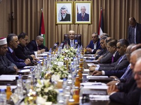 Palestinian Prime Minister Rami Hamdallah, center, chairs a reconciliation government cabinet meeting in Gaza City Tuesday, Oct. 3, 2017.  The Palestinian prime minister has held the first government meeting in Gaza as part of a major reconciliation effort to end the 10-year rift between Fatah and the militant Hamas group. (Mohammed Abed/Pool Photo via AP)