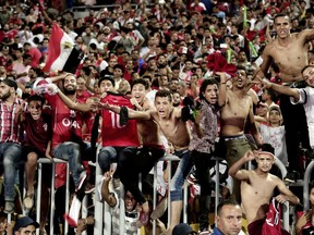 FILE - In this Sunday, Oct. 8, 2017 file photo, Egyptian fans celebrate after their win over Congo during the 2018 World Cup group E qualifying soccer match in Alexandria, Egypt. "Youm7," or Seventh Day, a Cairo daily, said in an article in the newspaper's online edition Wednesday, Oct. 18, 2017, that Egypt's qualification at next year's World Cup has made many male fans dream about traveling to Russia to meet local women and is warning them they should lower their expectations about meeting Russian women. (AP Photo/Nariman El-Mofty, File)