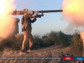 FILE - This photo posted online Thursday, Sept. 28, 2017, by supporters of the Islamic State group on an anonymous photo sharing website, purports to show an IS fighter firing a weapon during clashes with Syrian government troops in the eastern Syrian province of Deir el-Zour. While the U.S.-led coalition and Russian-backed Syrian troops have been focused on driving Islamic State from the country's east, an al-Qaida-linked insurgent coalition known as the Levant Liberation Committee has consolidated its control over Idlib, and may be looking to return to Osama bin Laden's strategy of attacking the West. (Militant Photo via AP, File)