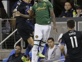 Portland Timbers forward Dairon Asprilla, center, jumps for the ball next to San Jose Earthquakes midfielder Shea Salinas during the first half of an MLS soccer match in San Jose, Calif., Saturday, Sept. 30, 2017.