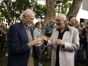 Scientists Barry Barish, left, and Kip Thorne, both of the California Institute of Technology, share a toast to celebrate winning the Nobel Prize in Physics Tuesday, Oct. 3, 2017, in Pasadena, Calif. Barish and Thorne won the Nobel Physics Prize on Tuesday for detecting faint ripples flying through the universe, the gravitational waves predicted a century ago by Albert Einstein that provide a new understanding of the universe. (AP Photo/Jae C. Hong)
