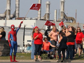 Striker Todd Scott, dressed in a Spiderman costume, joins fellow employees of the GM CAMI assembly factory on the picket line in Ingersoll, Ont., on Monday, Sept. 18, 2017.