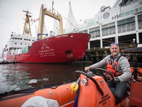 Expedition manager Scott McDougall, of Chelsea, Que., pilots a zodiac boat on the harbour where the Polar Prince ship is moored in Vancouver, B.C., on Monday Oct. 23, 2017.