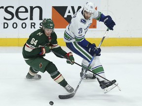 Minnesota Wild's Mikael Granlund and Vancouver Canucks' Brandon Sutter battle for the puck in the third period of their game Tuesday night in St. Paul, Minn. Vancouver won 1-0.
