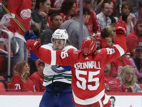 Jake Virtanen, left, of the Vancouver Canucks collides with Detroit Red Wings defenceman Niklas Kronwall during NHL action Sunday in Detroit. Virtanen was a going concern with a goal in a 4-1 Canucks' victory.