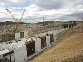 Crew members work to repair the damaged main spillway of the Oroville Dam, Thursday, Oct. 19, 2017, in Oroville, Calif. California officials say repair costs at the nation's tallest dam will be nearly double the original estimate of $275 million. The main spillway and emergency spillway suffered significant damage during storms last February, prompting fears of massive flooding. (AP Photo/Rich Pedroncelli)