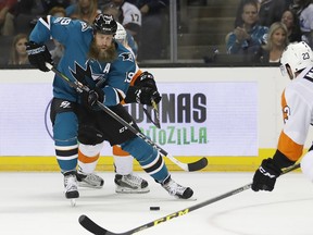 San Jose Sharks center Joe Thornton (19) advances the puck against the Philadelphia Flyers during the first period of an NHL hockey game, Wednesday, Oct. 4, 2017, in San Jose, Calif. (AP Photo/Tony Avelar)