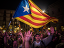 Pro-independence supporters cheer in Barcelona, Spain, after Catalonia's regional parliament passed a motion with which they say they are establishing an independent Catalan Republic, Friday, Oct. 27, 2017.