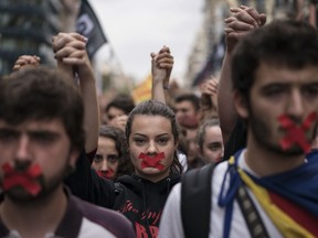 Independence supporters march during a demonstration in downtown Barcelona, Spain, Monday, Oct. 2, 2017.