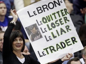 FILE - In this Thursday, Dec. 2, 2010, file photo, a fan displays her opinion of Miami Heat forward LeBron James return to Cleveland during the third quarter of an NBA basketball game against the Cleveland Cavaliers in Cleveland. With the return of Boston Celtic's Kyrie Irving on Tuesday, Oct. 17, 2017, in Cleveland, the fans will likely show their disfavor towards Irving. (AP Photo/Tony Dejak, File)