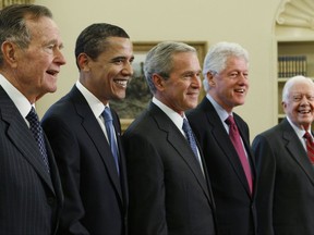 FILE - In this Jan. 7, 2009 file photo, Then-President George W. Bush, center, poses with President-elect Barack Obama, and former presidents, from left, George H.W. Bush, left, Bill Clinton and Jimmy Carter, right, in the Oval Office of the White House in Washington. All five living former U.S. presidents will be attending a concert Saturday night, Oct. 21, 2017, in a Texas college town, raising money for relief efforts from Hurricane Harvey, Irma and Maria's devastation in Texas, Florida, Puerto Rico and the U.S. Virgin Islands. (AP Photo/J. Scott Applewhite)