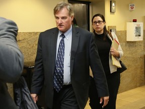 FILE - In this Friday, June 30, 2017 file photo, ex-Tulsa police officer Shannon Kepler, center, arrives at court with his legal team in his trial in Tulsa, Okla. A self-defense claim by Kepler who fatally shot his daughter's black boyfriend cast enough doubt for jurors to convict him on the lesser charge of manslaughter over first-degree murder, the jury forewoman said. Jurors convicted Kepler on Oct. 18, 2017, in his fourth trial for killing of 19-year-old Jeremey Lake in August 2014. (AP Photo/Sue Ogrocki File)