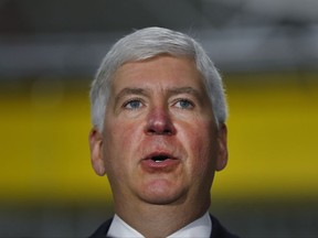 FILE - In this Sept. 18, 2017 file photo, Michigan Gov. Rick Snyder speaks at American Axle & Manufacturing in Auburn Hills, Mich. Gov. Snyder is sticking by his congressional testimony about when he learned about a fatal outbreak of Legionnaires' disease during the Flint water crisis, despite a senior aide's new disclosure that he informed the Republican governor weeks earlier. Some Democrats in Congress are pouncing on the conflict and urging the U.S. House Oversight and Government Reform Committee to investigate. (AP Photo/Paul Sancya, File)