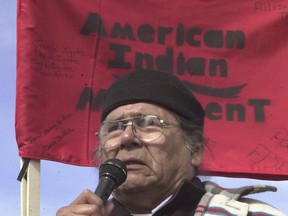 FILE - In this Feb. 27, 2003, file photo, Dennis Banks, one of the founders of the American Indian Movement (AIM), speaks to the crowd gathered to commemorate the 30th anniversary of the AIM standoff at Wounded Knee, S.D. The family of Banks says he died Sunday, Oct. 29, 2017, at the age of 80. Banks was a co-founder of AIM and a leader of the Wounded Knee occupation in 1973. (AP Photo/Doug Dreyer File)