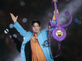 FILE - In this Feb. 4, 2007 file photo, Prince performs during halftime of the Super Bowl XLI football game in Miami. Two sisters and heirs of the late rock superstar Prince said Wednesday, Oct. 11, 2017, they're angered that the contents of his vault, including master tapes of unreleased music, have been removed from his Paisley Park studio complex and shipped to California. (AP Photo/Chris O'Meara, File)