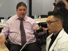 Federal Disabilities Minister Kent Hehr gets a demonstration of the LipSync, a device that allows users to control computers by blowing through a straw from Ivan Gourlay, an engineer from Makers Making Change in Calgary on, October 27, 2017. THE CANADIAN PRESS/Bill Graveland