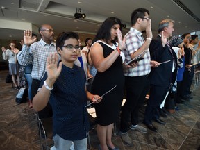 Luiz capitulino,11, of Brazil joins others in the oath as they become official Canadians during a citizenship ceremony at the National Arts Centre in Ottawa on Monday, Sept. 25, 2017.