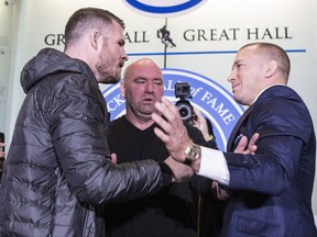 Canadian fighter Georges St-Pierre (right) and British fighter Michael Bisping square off as they promote UFC 217 during a news conference in Toronto on Friday October 13, 2017. THE CANADIAN PRESS/Chris Young