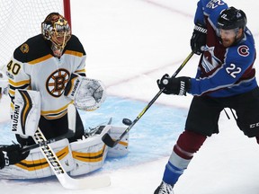 Boston Bruins goalie Tuukka Rask, left, of Finland, stops a redirected shot off the stick of Colorado Avalanche center Colin Wilson in the first period of an NHL hockey game Wednesday, Oct. 11, 2017, in Denver. (AP Photo/David Zalubowski)