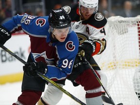 Colorado Avalanche right wing Mikko Rantanen, front, of Finland, fights for control of the puck with Anaheim Ducks defenseman Cam Fowler during the first period of an NHL hockey game Friday, Oct. 13, 2017, in Denver. (AP Photo/David Zalubowski)