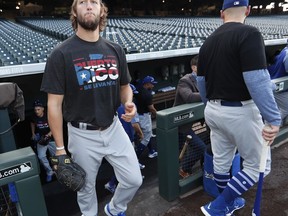 Los Angeles Dodgers starting pitcher Clayton Kershaw wears a Hurricane Maria shirt to rise money for relief efforts in Puerto Rico before a baseball game against the Colorado Rockies, Friday, Sept. 29, 2017, in Denver. (AP Photo/David Zalubowski)