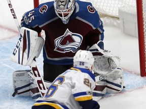 Colorado Avalanche goalie Jonathan Bernier, back, makes a stick save on a shot from St. Louis Blues center Paul Stastny during the first period of an NHL hockey game Thursday, Oct. 19, 2017, in Denver. (AP Photo/David Zalubowski)