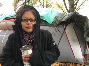 Chrissy Brett is shown at the Oak Bay homeless camp in Victoria, Wednesday, Oct.18, 2017. A nomadic group of homeless people has chosen one of Canada's wealthiest communities to pitch some tents and draw attention to housing shortages for disadvantaged people across British Columbia. THE CANADIAN PRESS/Dirk Meissner