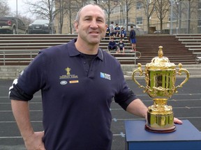 Former Canadian rugby captain Al Charron poses with the Webb Ellis Cup at St. Michael?s College School during the Canadian stop in Toronto Thursday, April 2, 2015 on the international Rugby World Cup Trophy Tour. Former Canada captain Charron is headed to the World Rugby Hall of Fame. THE CANADIAN PRESS/Neil Davidson
