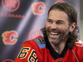 Jaromir Jagr has a laugh after being introduced as the newest Calgary Flames player at a press conference in Calgary, Alta., on Oct. 4, 2017. Jaromir Jagr opted not to play in the Calgary Flames home-opener Saturday against the Winnipeg Jets. Flames head coach Glen Gulutzan said the 45-year-old winger, who signed a contract Sunday and arrived in Calgary three days later, needs a couple more skates before he feels ready to get in the lineup. THE CANADIAN PRESS/Larry MacDougal