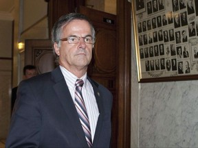 Chomedey MLA Guy Ouellette walks from a government caucus meeting Tuesday, October 25, 2011 at the legislature in Quebec City. THE CANADIAN PRESS/Jacques Boissinot