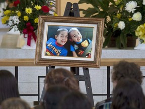 A portrait of the young brothers on the altar at the funeral for Noah and Connor Barthe at St. Thomas Aquinas Roman Catholic Church in Campbellton, N.B. on Saturday, Aug. 10, 2013.