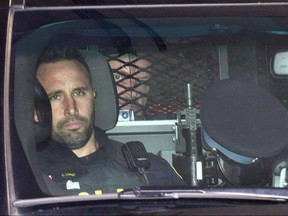 Basil Borutski (back) leaves in a police vehicle after appearing at the courthouse in Pembroke, Ont. on Sept. 23, 2015. A man charged with killing three women in the Ottawa Valley in 2015 is refusing to enter a plea as his first-degree murder trial gets underway. THE CANADIAN PRESS/Justin Tang