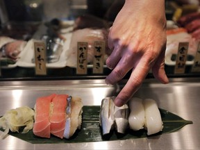 A chef serves sushi at a restaurant in Tokyo, Tuesday, April 23, 2013. As these fearless foodies come of age, they are giving the restaurant industry plenty to chew on. THE CANADIAN PRESS/AP-Itsuo Inouye