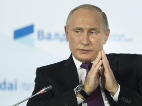 Russian President Vladimir Putin gestures while speaking at the plenary session of the an annual meeting of the Valdai International Discussion Club in the Black Sea resort of Sochi, Russia on October 19, 2017. Russian President Vladimir Putin is accusing Canada of playing "unconstructive political games" by passing its own Magnitsky law this week. Putin made the comments in Sochi at an international forum in which he fielded a wide range of questions. THE CANADIAN PRESS/AP, Alexander Zemlianichenko, POOL