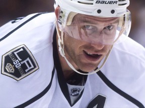 Los Angeles Kings' Jeff Carter smiles while lining up for a faceoff during first period NHL hockey action against the Vancouver Canucks, in Vancouver, B.C., on March 31, 2017. Los Angeles Kings centre Jeff Carter is out indefinitely after undergoing surgery to repair a cut on his left leg.Kings general manager Rob Blake announced his star power forward's injury Thursday. THE CANADIAN PRESS/Darryl Dyck