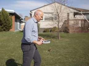 Alberta Party Leader Greg Clark goes door knocking while on the campaign trail in Edmonton, Alta., on Monday, April 27, 2015. Alberta party Leader Clark is no longer alone in the legislature.Former Calgary NDP member Karen McPherson has joined his caucus, bringing the total to two in the legislature.THE CANADIAN PRESS/Jason Franson