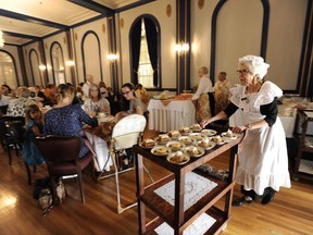Carol Johnston, right, rolls out the dessert cart at the Government House Historical Society Victorian tea in Regina on Sunday, September 10, 2017. THE CANADIAN PRESS/Mark Taylor
