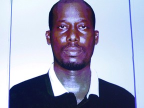 An image of Ali Omar Ader is projected on a screen at RCMP headquarters during a press conference about his arrest for the kidnapping of Canadian journalist Amanda Lindhout, in Ottawa on June 12, 2015. An emotional Amanda Lindhout recounted the horrors of being kidnapped at gunpoint in Somalia as the trial of one of her alleged hostage-takers got underway.THE CANADIAN PRESS/ Patrick Doyle